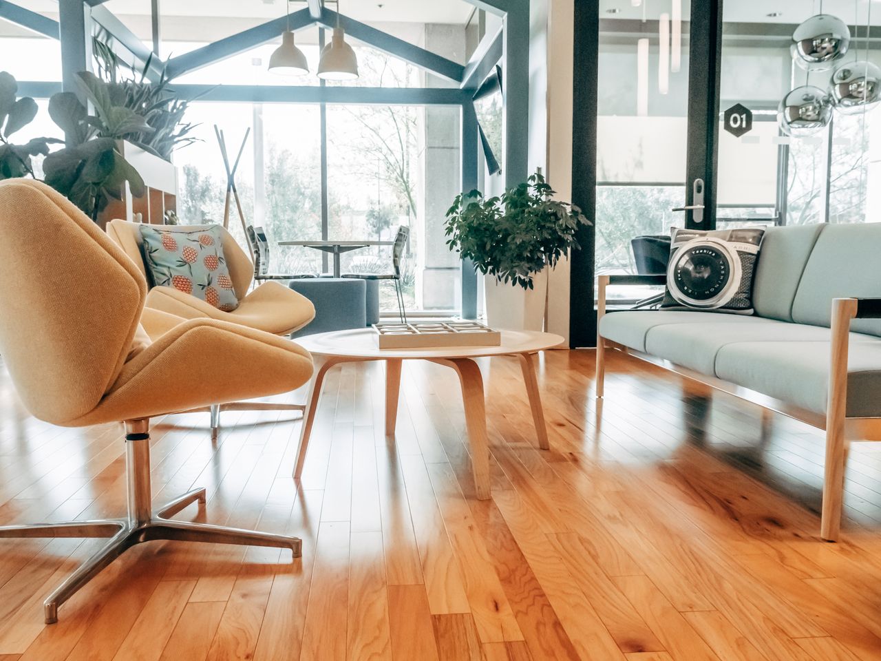 Elegant modern living room featuring chic furniture, warm lighting, and wooden flooring.